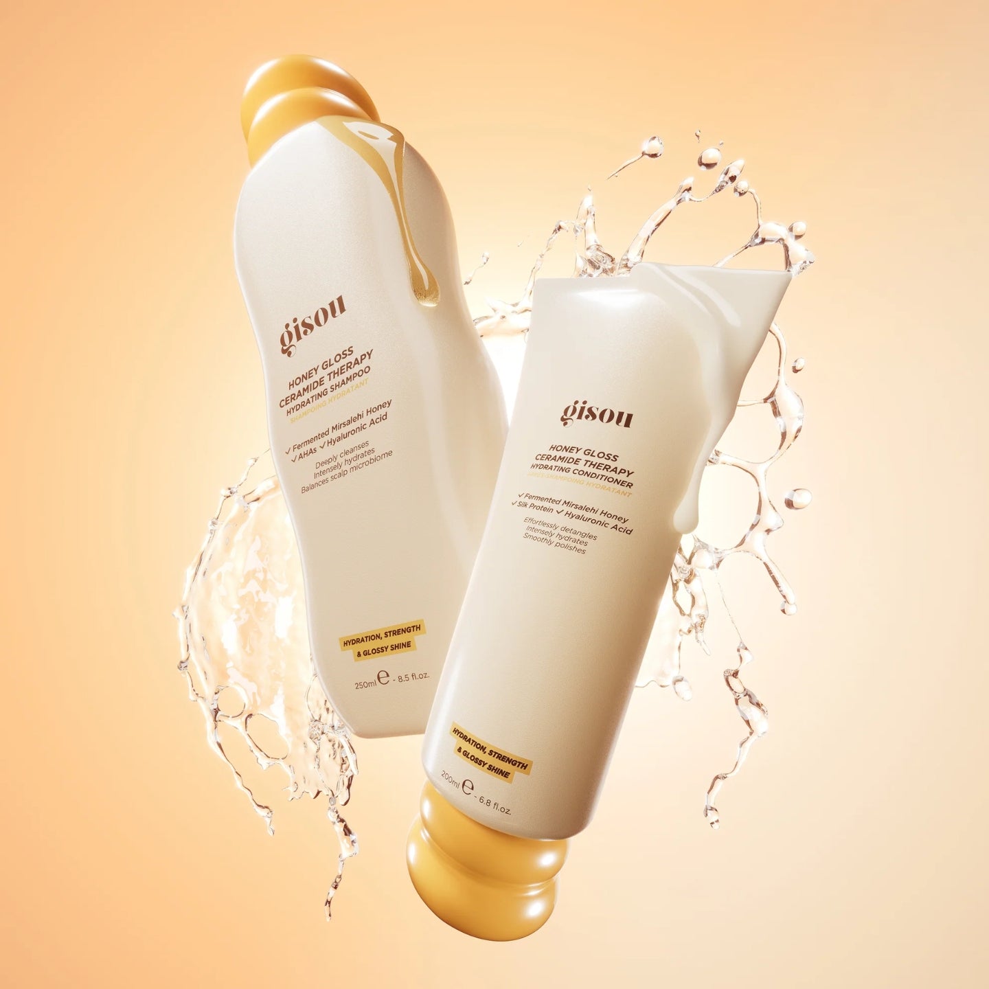 Two bottles of gison shampoo and conditioner with water splashes on a beige background
