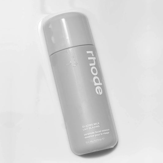 Gray bottle of 'rhode' glazing milk on a white background